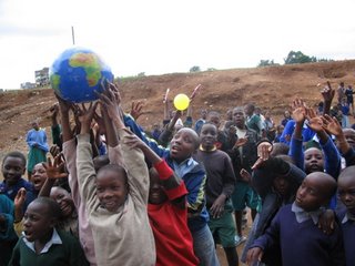 Students play with a globe and sun