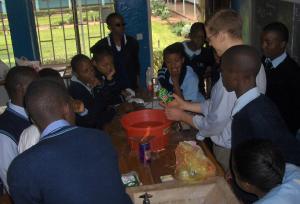 Students look at a crushed can