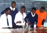 Students extinguish matches in jars